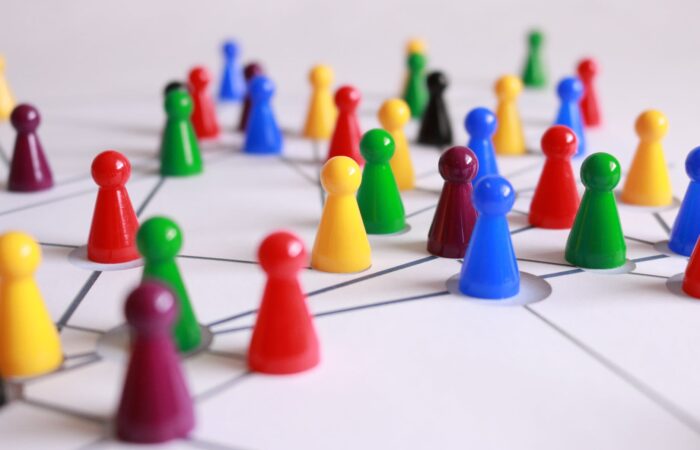 close up photography of yellow green red and brown plastic cones on white lined surface